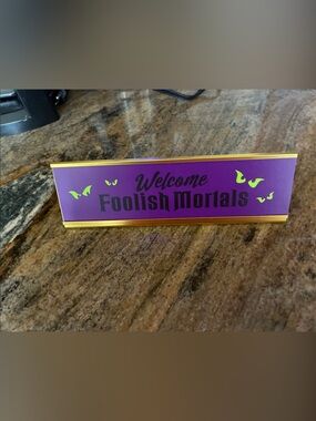 Disney Purple and Gold "Welcome Foolish Mortals" Desk Sign